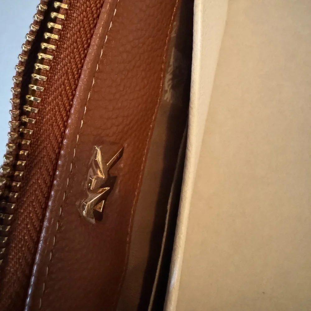 Anne Klein AK Logo Slim Zip Around Wallet in a two-tone Cream and Brown/Saddle